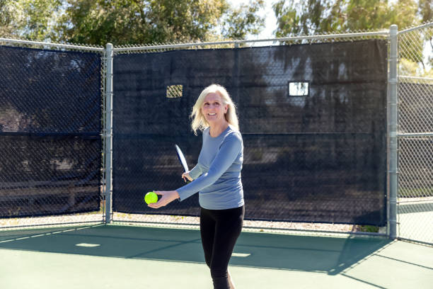 istock Senior woman playing pickleball 2148649773