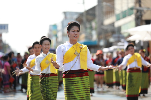 Lampang, Thailand, April 13, 2024: Performers with beautiful females and Hansom male actors in traditional costume in Lanna style take part in a parade to celebrate the Salung Luang Klong Yai Festival