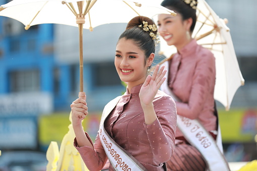 Lampang, Thailand, April 13, 2024: Performers with beautiful females and Hansom male actors in traditional costume in Lanna style take part in a parade to celebrate the Salung Luang Klong Yai Festival