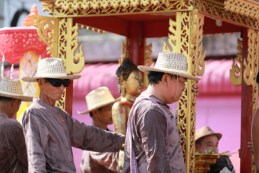 Lampang, Thailand, April 13, 2024: Performers with beautiful females and Hansom male actors in traditional costume in Lanna style take part in a parade to celebrate the Salung Luang Klong Yai Festival