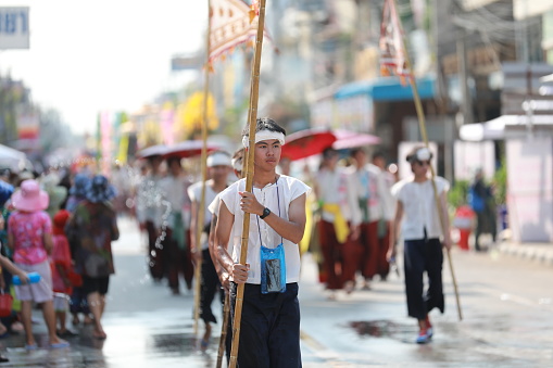 Lampang, Thailand, April 13, 2024: Performers with beautiful females and Hansom male actors in traditional costume in Lanna style take part in a parade to celebrate the Salung Luang Klong Yai Festival