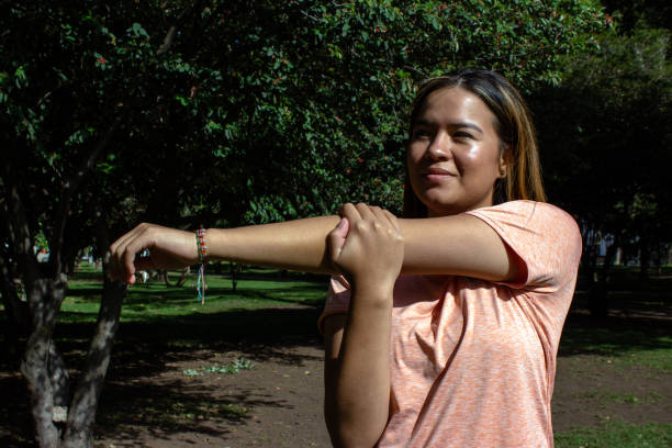 istock Beautiful young woman doing exercise in a public park 2148650621