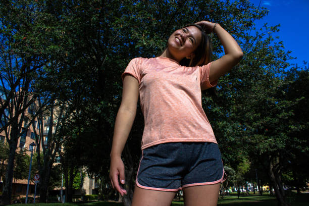 istock Beautiful young woman doing exercise in a public park 2148650625