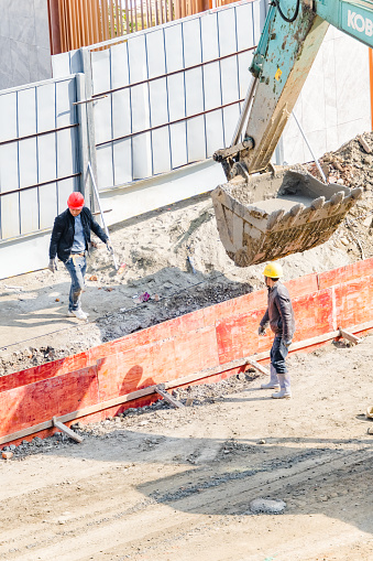 On February 29, 2024, on a sunny day in Shuangliu District, Chengdu, Sichuan Province, middle-aged workers were shoveling cement at the construction site