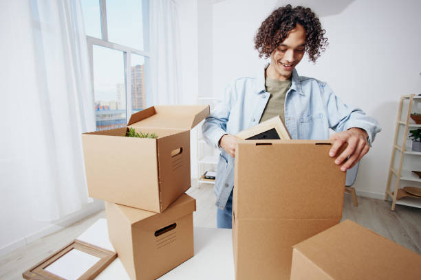 istock handsome guy unpacking things from boxes in the room Lifestyle 2148652349
