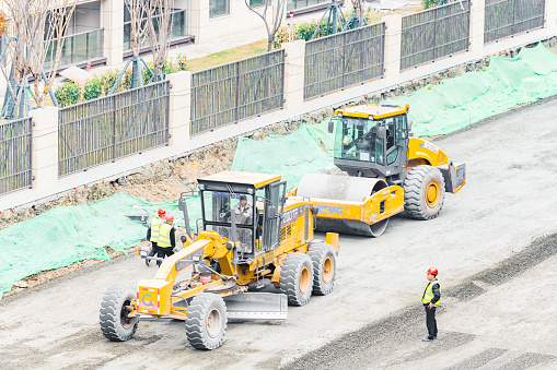 On a sunny day on March 16, 2024, a road roller and a grader intersected on a construction site in Shuangliu District, Chengdu, Sichuan Province