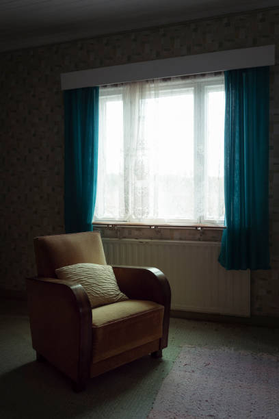 An armchair and a pillow in front of the window as it was decades ago