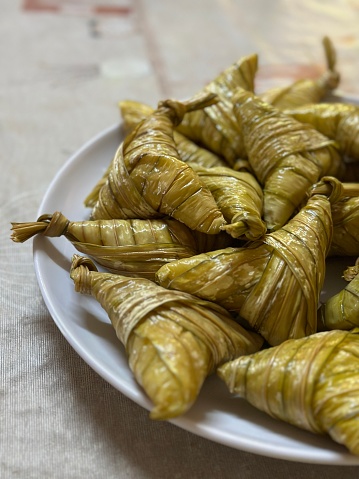 Popular Malaysian Traditional food for Hari Raya or lebaran. Delicious local food Ketupat Palas eaten with beef or chicken rendang and serunding.