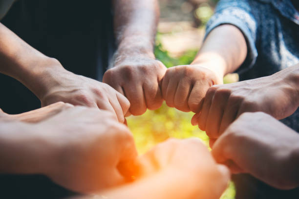 istock Diverse multiethnic Partners hands together teamwork group of multiracial people meeting join hands togetherness. Diversity people hands join empower partnership teams connection volunteer community 2148654635