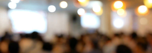 istock Blurred background people join seminar business event in auditorium hall convention.  Presentation meeting at conference room present screen business. Blurred background with copy space 2148654737