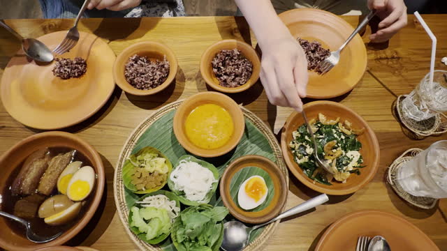 Eating Thai food in restaurant