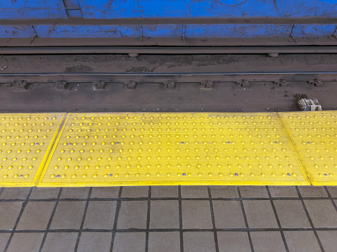Anti-slippery warning pad in subway station in New York City