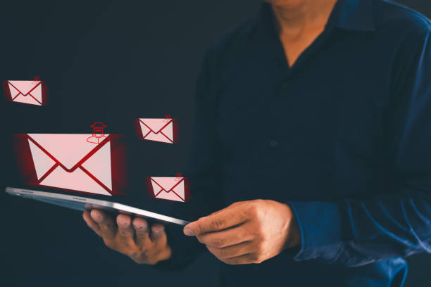 istock Male hand using tablet showing dangerous email icons Internet spam emails, hackers 2148658266