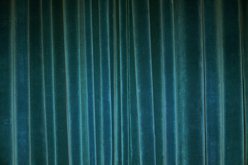Vertical fold on green velvet curtains for background and design. Soft focus