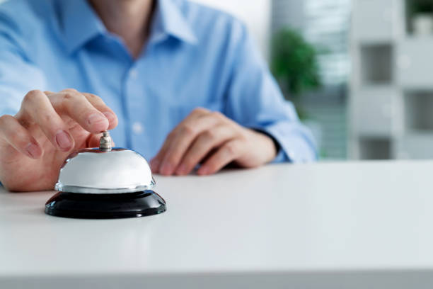 Businessman hand ringing a service bell.