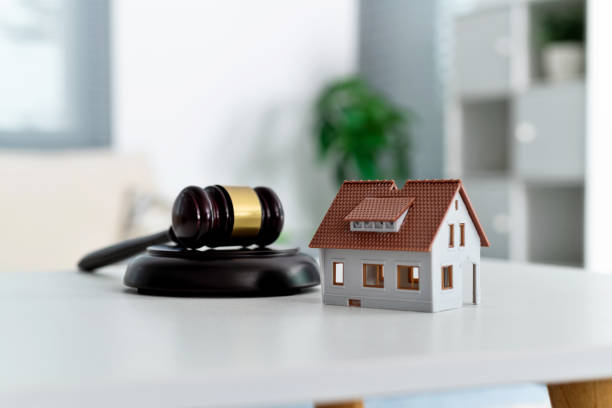 istock Model house and gavel on the table 2148659723