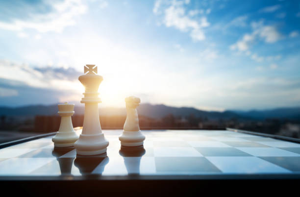 istock Chess king, pawn and knight on city background 2148659738