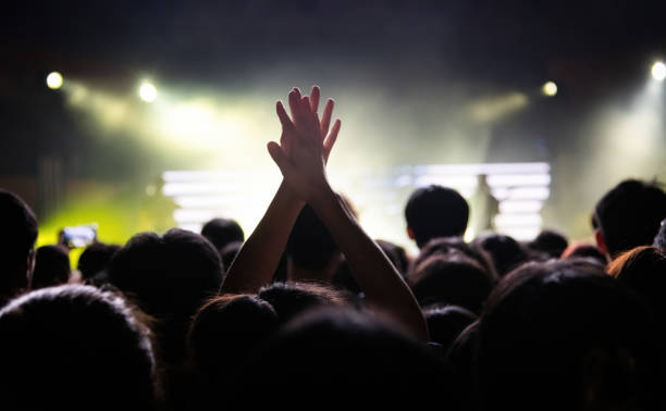 People clapping hands at music festival