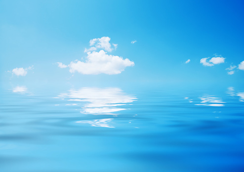 Blue sky and white cloud reflected in the water