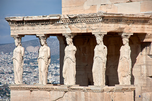 Porch Ruins of Caryatids Temple of the Acropolis of Erechtheum Athens Greece. Greek maiden columns in the Erechtheion temple for a former Athenian king. The Acropolis is the symbol of Athens