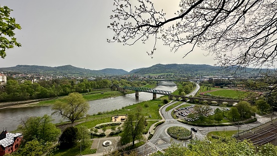 Confluence of rivers in the city, roundabout ,view of the city cell around the river, warm spring weather, photographed from a forest viewpoint without people