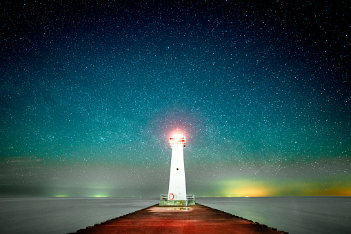 The View of Starry Night Over The Woods and Lighthouse in Lake Ontario