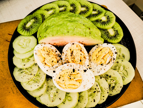 Low carb high protein lunch with egg cucumber and fruits