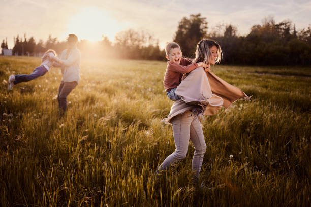 istock Cheerful family having fun in the park at sunset. 2148665582