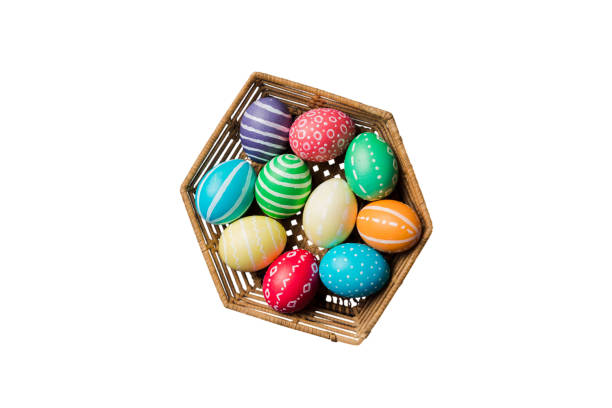 Basket of colorful Easter eggs isolated on white background. Easter basket filled with colored eggs top view holiday concept .
