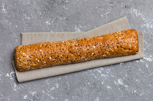 fresh crunchy french baguette on colored table. Top view Bakery products.