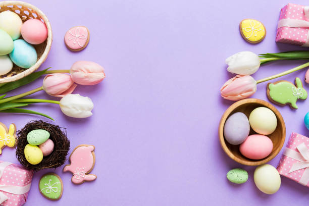istock Easter frame with eggs, gift box and tulip on a colored background. The minimal concept. Top view Happy Easter composition. Card with a copy space of the place for the text 2148665749