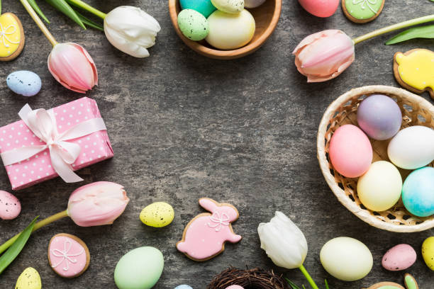 istock Easter frame with eggs, gift box and tulip on a colored background. The minimal concept. Top view Happy Easter composition. Card with a copy space of the place for the text 2148665750