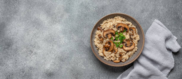 istock Risotto with royal mushrooms on a gray rustic background. Top view, flat lay, copy space. Banner 2148665868