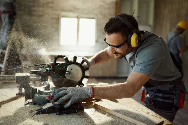 istock Manual worker cutting plank with electric saw while working on home renovation. 2148665904