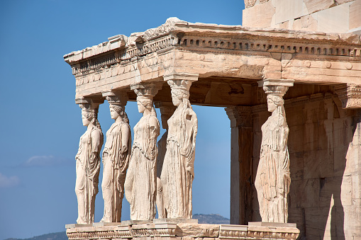 Porch Ruins of Caryatids Temple of the Acropolis of Erechtheum Athens Greece. Greek maiden columns in the Erechtheion temple for a former Athenian king. The Acropolis is the symbol of Athens