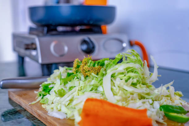 A pile of chopped vegetables in kitchen counter cabbage carrot etc.