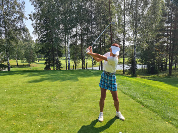 istock Woman   Swinging Golf Club on Golf Course 2148667254