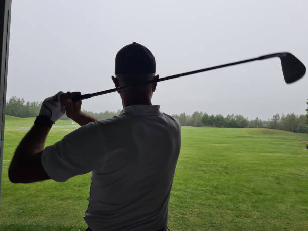 istock Man Swinging Golf Club at Golf Course 2148667255