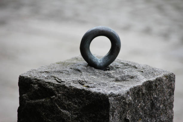 A stone with a metal round hanger on it