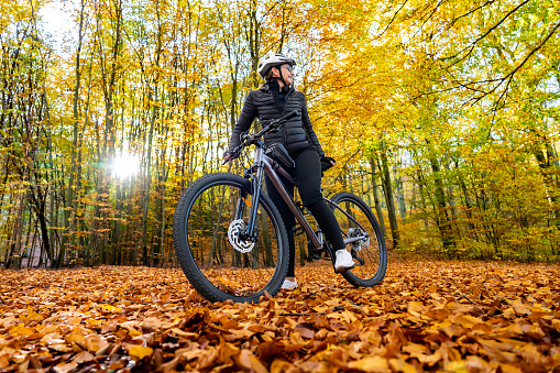 Woman riding bike in forest
