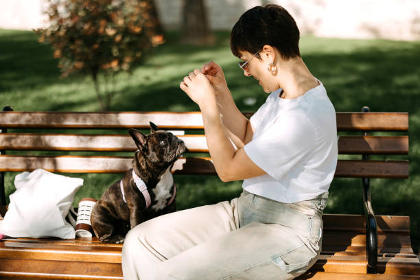 istock Woman in the park with her dog 2148669780