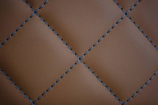 istock Blue contrast thread on a brown leather car seat 2148669813