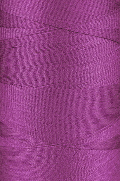 istock Texture of pink color threads in spool close up, macro 2148670120