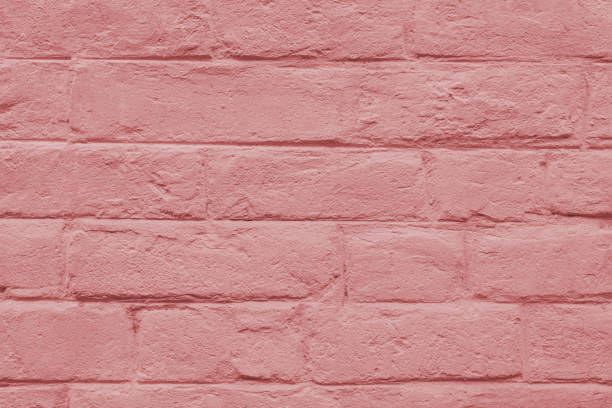 Abstract weathered masonry, aged texture. Stained old stucco red painted  brick wall background, grungy rusty blocks of brickwork close up. Wallpaper, backdrop