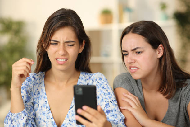 istock Two friends watching nasty content on phone 2148670351
