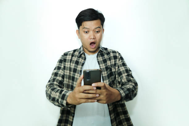 istock Young Asian man shocking looking at smartphone 2148671583