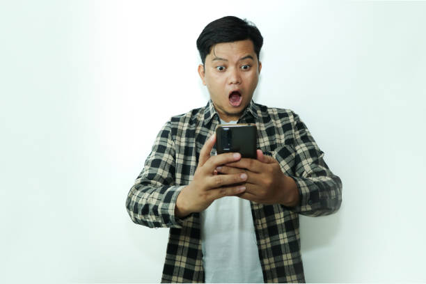 istock Young Asian man shocking looking at smartphone 2148671590
