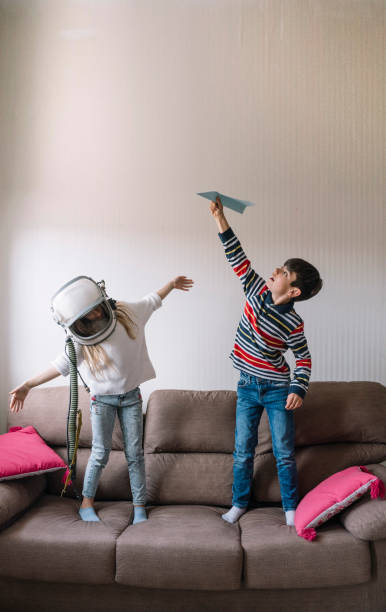 istock Two kids playing with the paper plane 2148671688