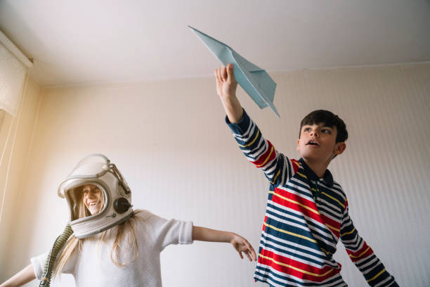 istock Two kids playing with the paper plane 2148671692