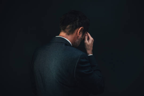 Rear view of sad depressed businessman